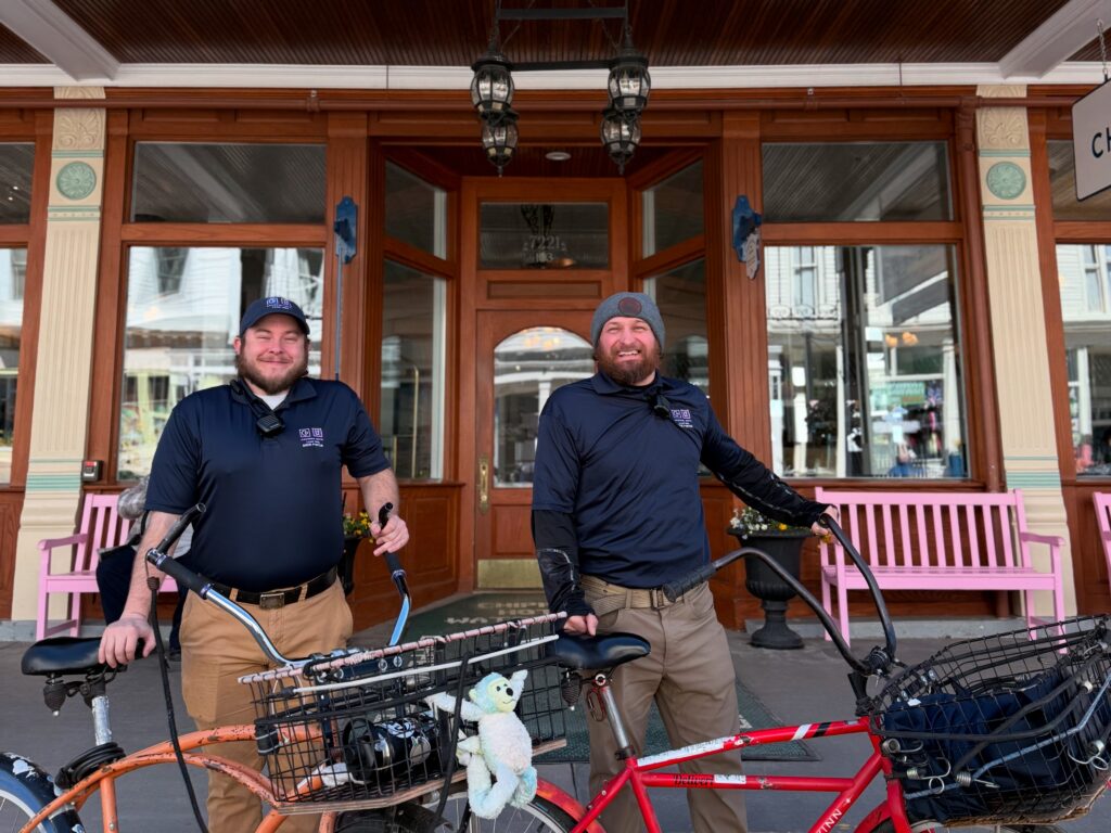 chippewa hotel dock porter with their bicycle bringing luggage from the ferry on mackinac island